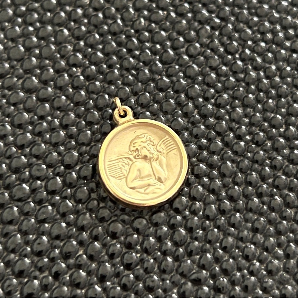This dainty 14 gf cherub angel pendant.